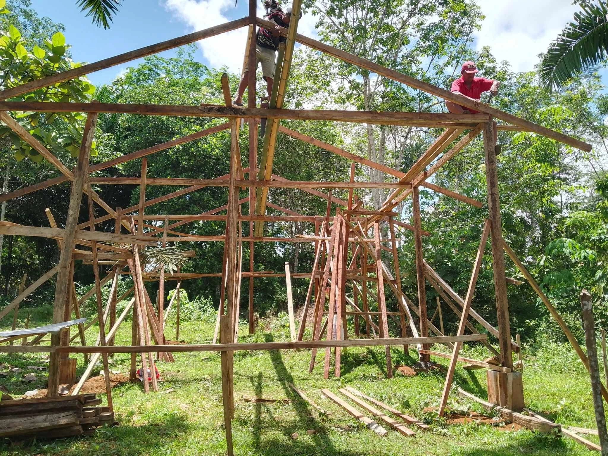 Volunteers and workers carrying out structural rebuilding work in a flood-affected area